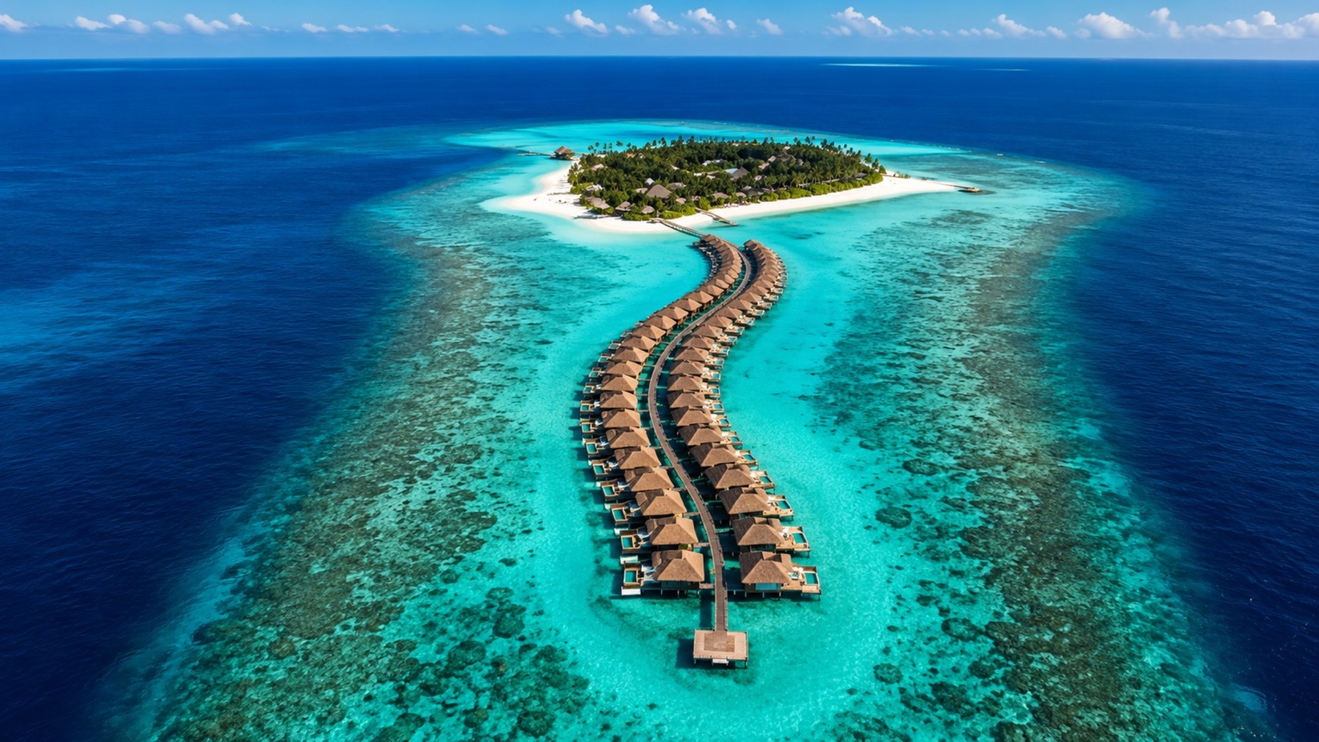 Aerial view of luxury overwater villas at a Maldives island resort